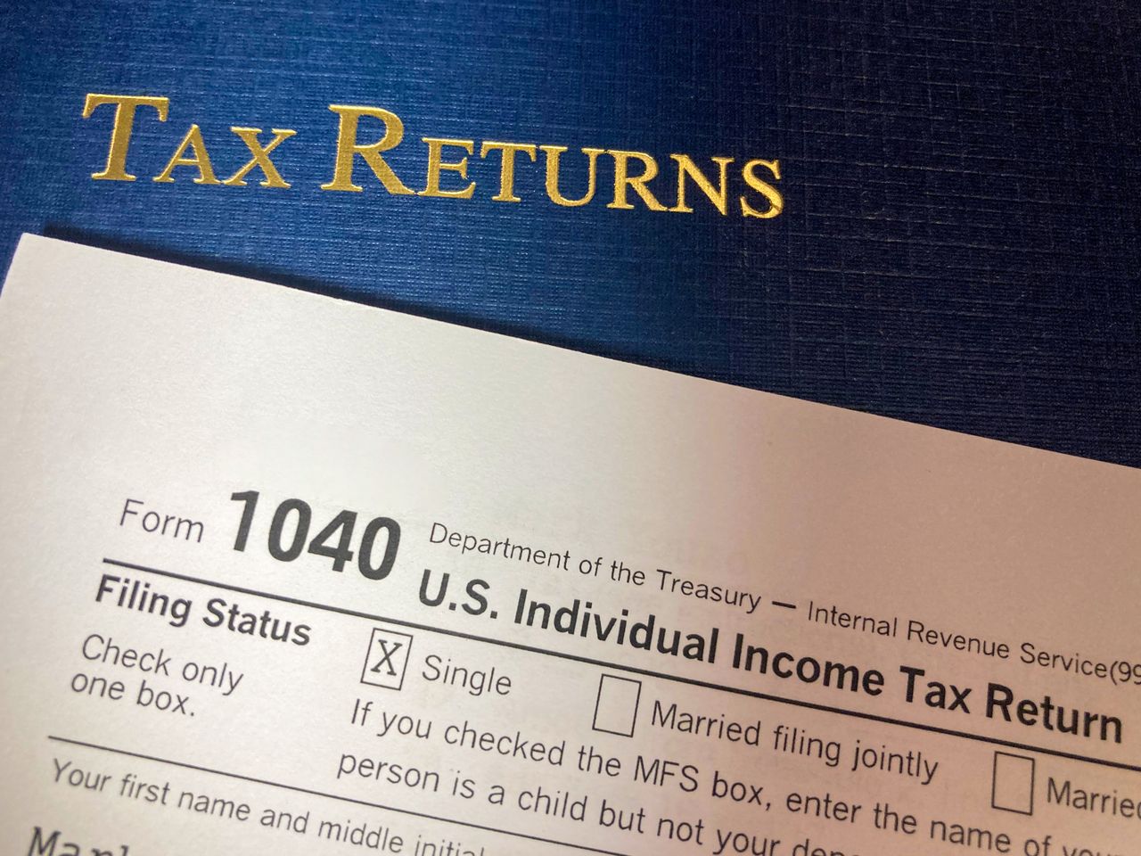 about-01 Close-up image of Form 1040 for U.S. tax returns, highlighting filing status options.